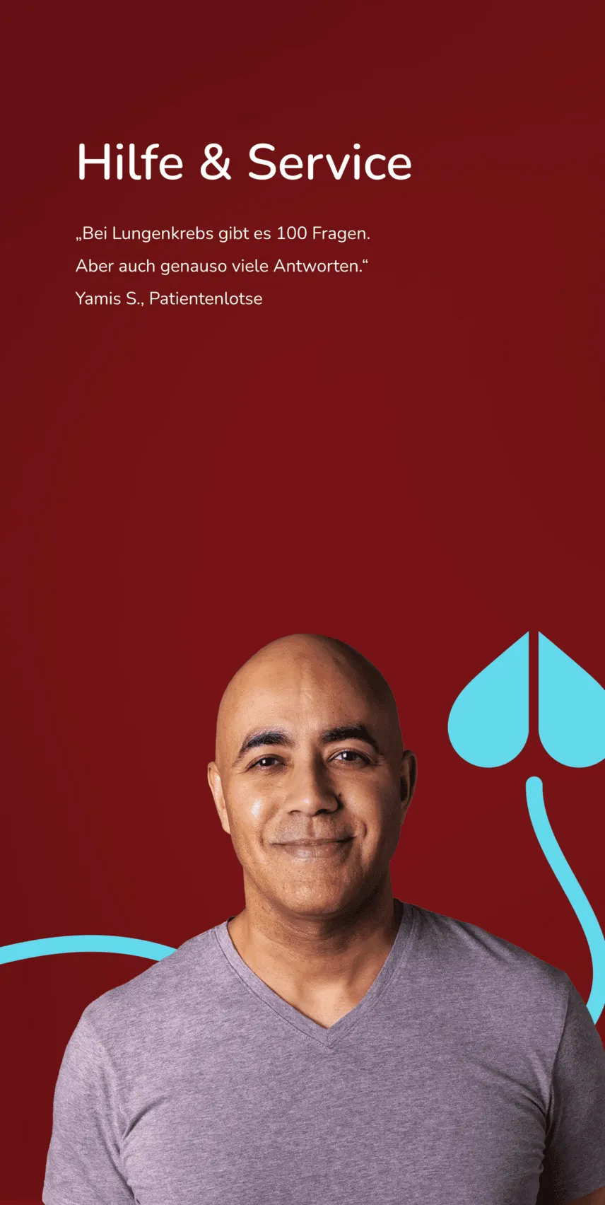 Ein Mann mit Glatze in lila T-Shirt steht vor einem grauem Hintergrund.